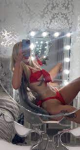 a woman wearing in front of a mirror wearing a red swim suit