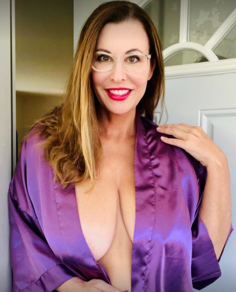 Spanish OnlyFans Creator from Spain named Elaina @elaina_stjames wearing a robe standing next to a door