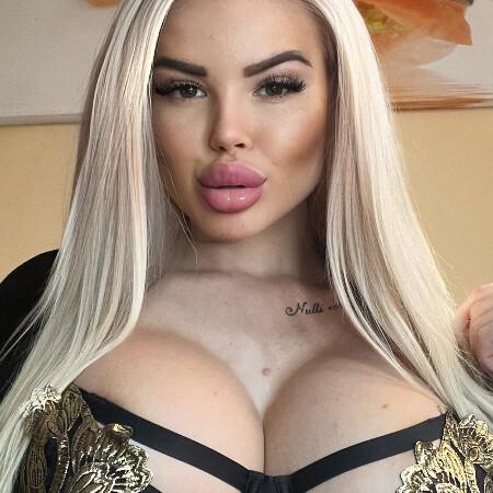 @barbiekristina a barbie doll or a barbie bimbo on onlyfans with blonde hair showing her big pink lips.