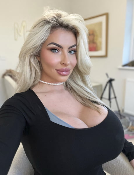 @maddison.fox a british bimbo on onlyfans wearing black top and pearl necklace. 