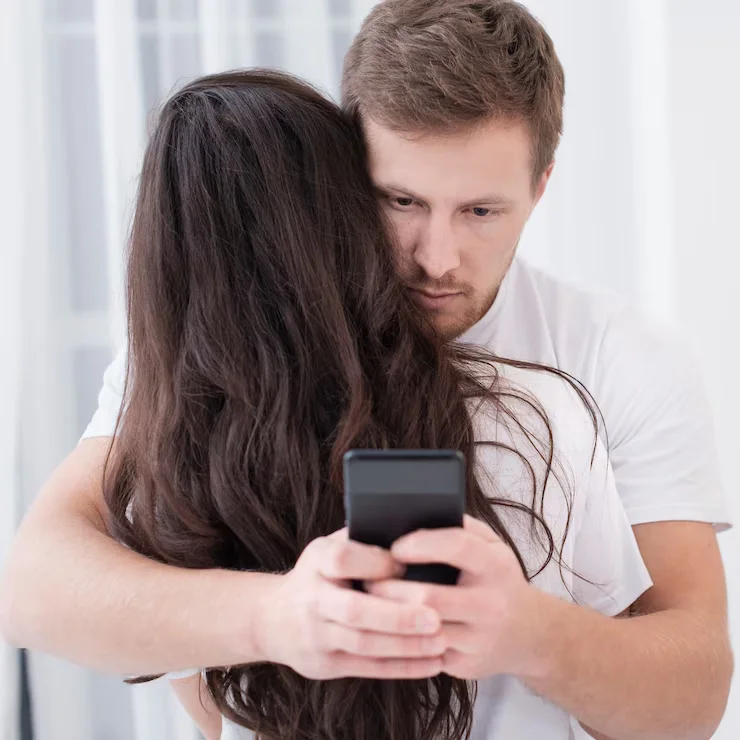 cheating onlyfans. man hugging a woman and he is using phone