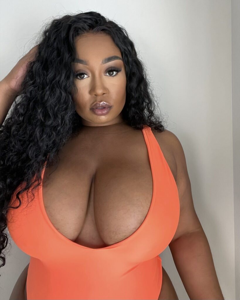 Brittney Tonee OnlyFans busty model wearing an orange top