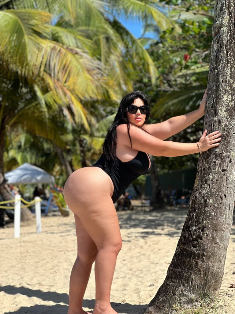 Nicole Nurko OnlyFans chubby model wearing black one piece bikini at the beach
